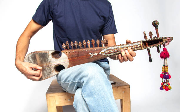 man-playing-rubab-a-eastern-folk-stringed-instrument-of-northern-pakistan-isolated-on-white